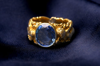 French Art Nouveau gold figural ring with a 4.2 carat Ceylon sapphire