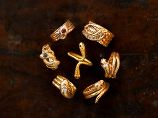 A collection of antique gold snake rings set with diamonds, sapphires, rubies and garnets