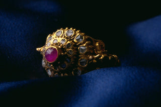 Antique Siamese gold mondop ceremonial ring with a star ruby cabochon