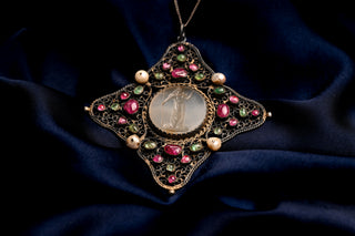 Silver filigree quatrefoil pendant set with cabochon rubies and emeralds