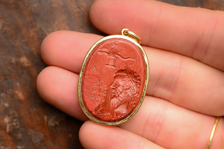 Magical gem style intaglio pendant with hand grasping a serpent