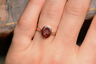 Carnelian signet ring on the finger for scale