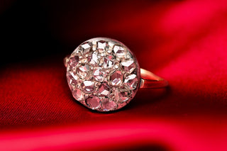 Antique rose cut diamond cluster ring, c.1900, front view on red satin