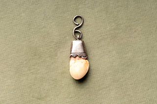 Antique Alpine silver-mounted red deer tooth amulet pendant