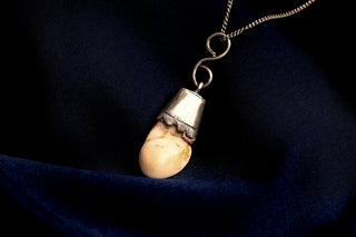 Grandl tooth pendant, side view on chain