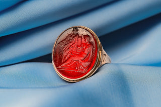 Classical intaglio scene of Apollo and Fortuna in red glass