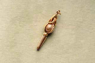 Antique gold watch key showing frosted oval bead and rope-twist bands